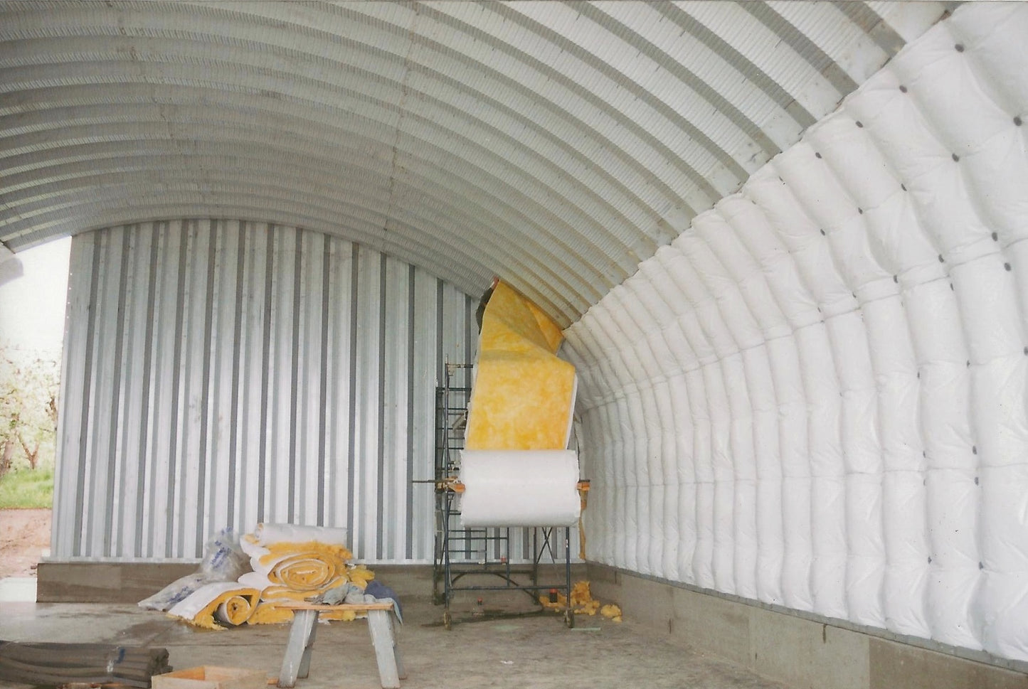Plastic insulation pins used to install fiberglass insulation in a steel arch quonset building